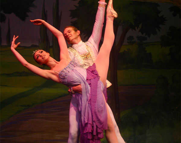 ballet performers in white and purple